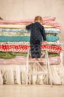 Child climbs on the bed - Princess and the Pea.
