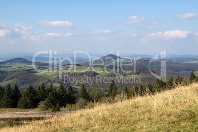 Landscape with small mountains in the background.