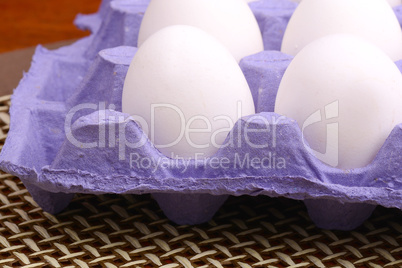 close up of eggs in cardboard container