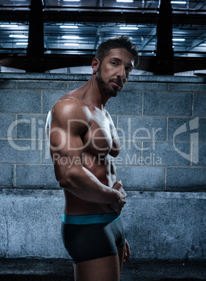 Muscular Man in Underwear Posing Inside a Building