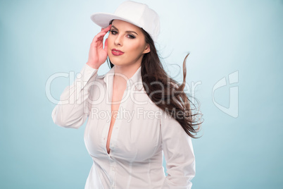 Woman in White Fashion with Cap Showing Cleavage