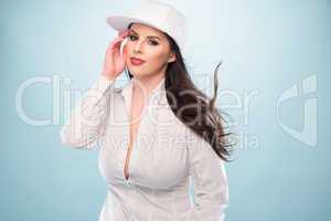 Woman in White Fashion with Cap Showing Cleavage