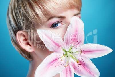 Pretty Face of a Blond Woman Covered with Flower