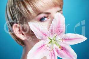 Pretty Face of a Blond Woman Covered with Flower