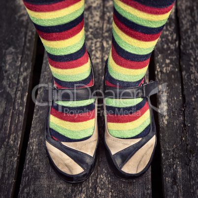 Female legs in striped socks in vintage style