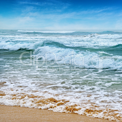 seascape, sand beach and blue sky