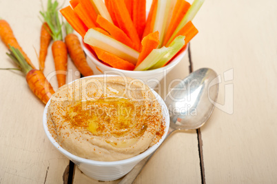 fresh hummus dip with raw carrot and celery