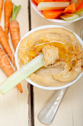 fresh hummus dip with raw carrot and celery