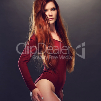Seductive Woman Posing in Red Long Sleeved Leotard
