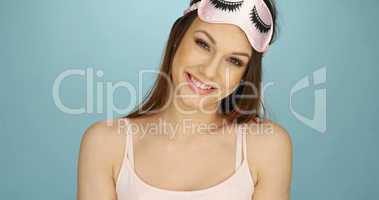 Pretty young woman with a sleep mask