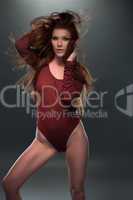 Seductive Woman Posing in Red Long Sleeved Leotard