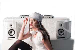 Trendy sexy DJ dressed in white mixing music