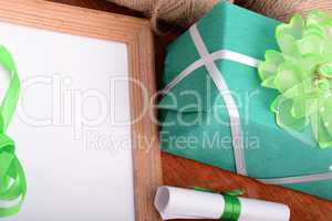 green gift box and wooden board, holiday concept