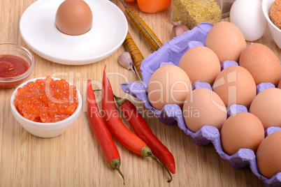 eggs on eggshell and red pepper, red caviar and tomato