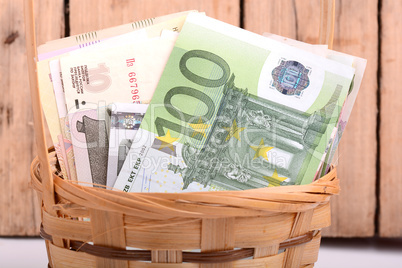money set in a basket, dollars, euro and russian money
