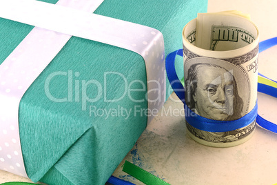 american money dollars and green gift box