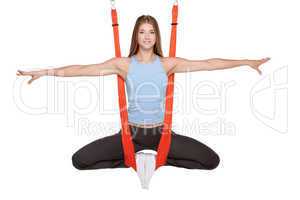 Young woman doing anti-gravity aerial yoga