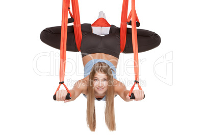 Young woman making antigravity yoga exercises in stretching twine