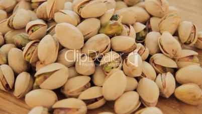 Roasted pistachios turn on wood plate