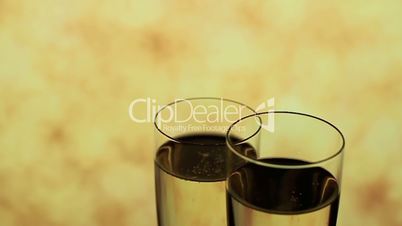 Two Champagne glasses as wedding rings symbol, blurred background, video