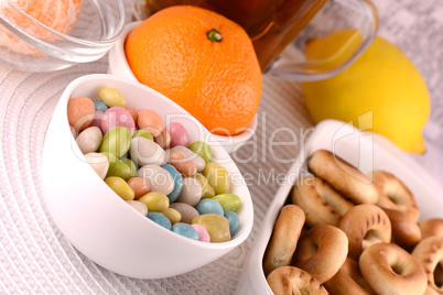 candies and fruits, tea (coffee) cup and fruits