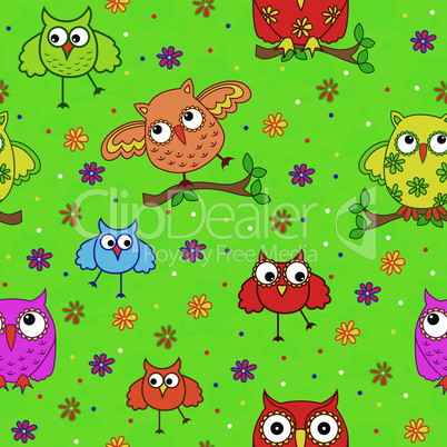 Seamless pattern with ornamental owls over green