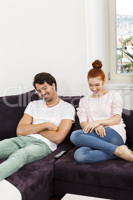 Happy Young Sweet Couple Sitting at the Couch