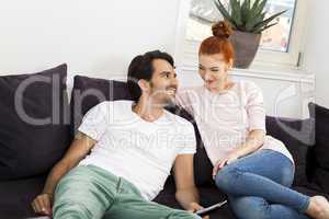 Happy Young Sweet Couple Sitting at the Couch