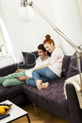 Happy Young Sweet Couple Sitting at the Couch