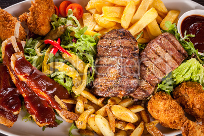 Platter of mixed meats, salad and French fries