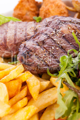 Platter of mixed meats, salad and French fries