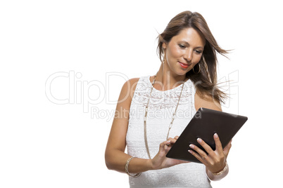 Woman chatting on a mobile while reading a tablet