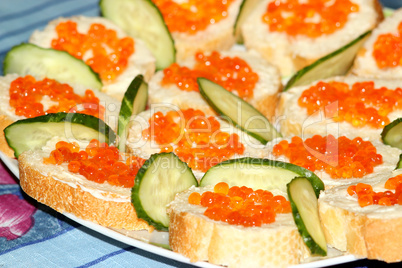sandwiches with red caviar and cucumber