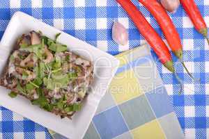 mushroom salad and red pepper on white plate