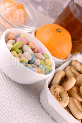 candies and fruits, tea (coffee) cup and fruits