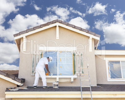 House Painter Painting the Trim And Shutters of Home