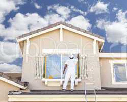 House Painter Painting the Trim And Shutters of Home
