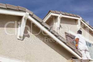 House Painter Painting the Trim And Shutters of Home