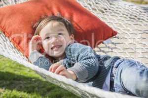 Cute Mixed Race Boy Relaxing in Hammock