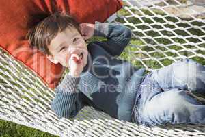 Cute Mixed Race Boy Relaxing in Hammock