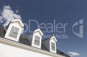 Roof of House and Windows Against Deep Blue Sky