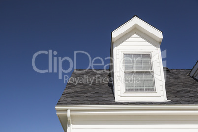 Roof of House and Windows Against Deep Blue Sky