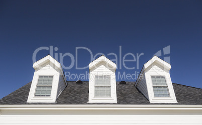 Roof of House and Windows Against Deep Blue Sky