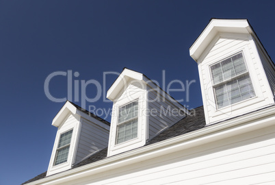 Roof of House and Windows Against Deep Blue Sky