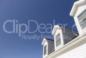 Roof of House and Windows Against Deep Blue Sky