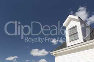 Roof of House and Windows Against Deep Blue Sky