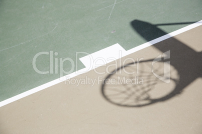 Shadow of Basketball Hoop and Net Against Court