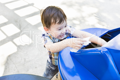 Cute Mixed Race Boy Placing Paper Into Recycle Bin