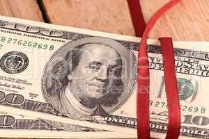 Bundle of dollars tied with ribbon