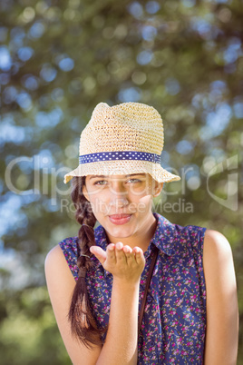 Pretty hipster blowing a kiss